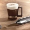 chrome aerolatte milk frother next to a coffee